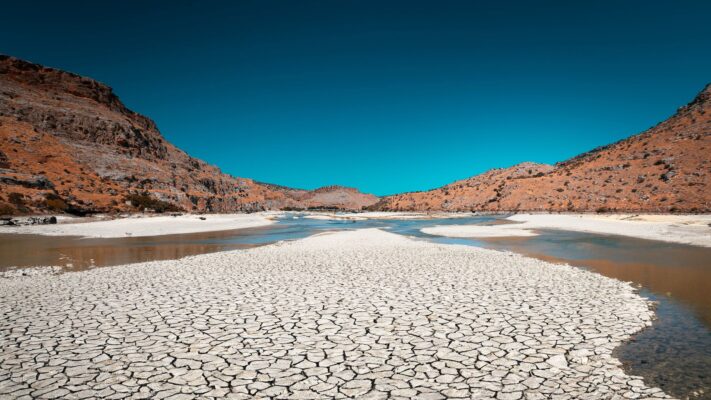 A water management facility built beside a drying reservoir, symbolizing the worsening water scarcity.